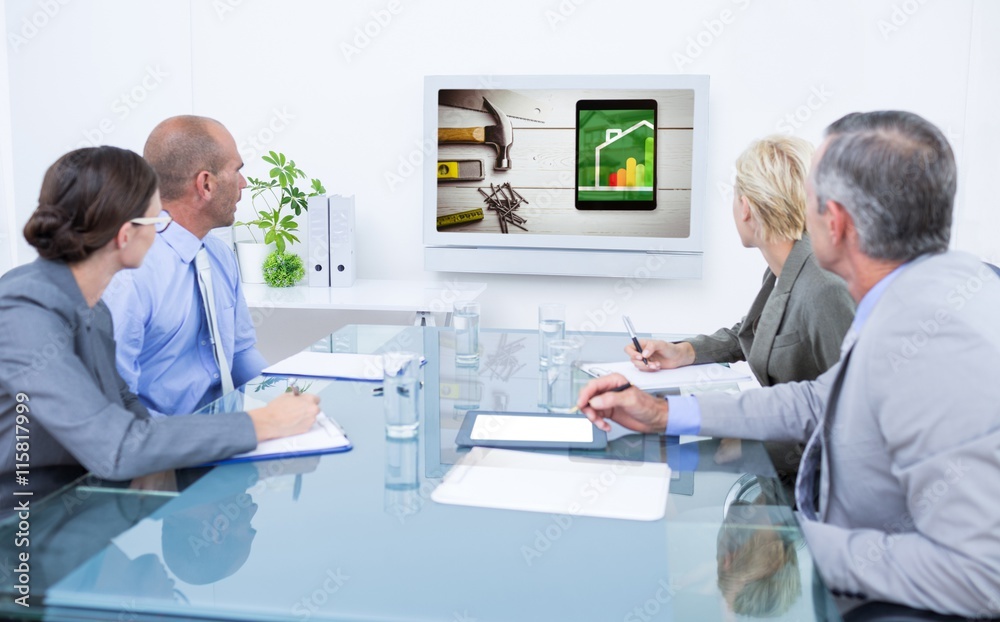 Composite image of business team looking at time clock 