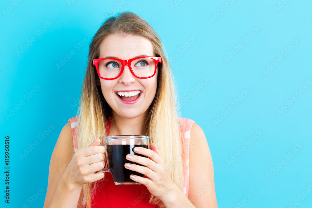 Happy young woman drinking coffee