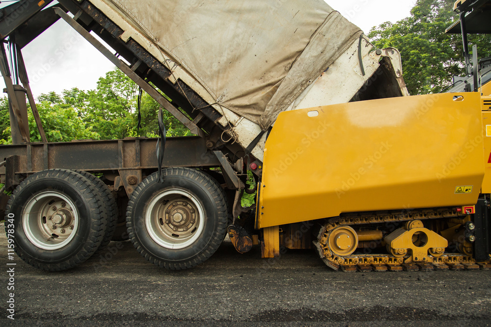 Road construction works with roller compactor machine and asphalt finisher