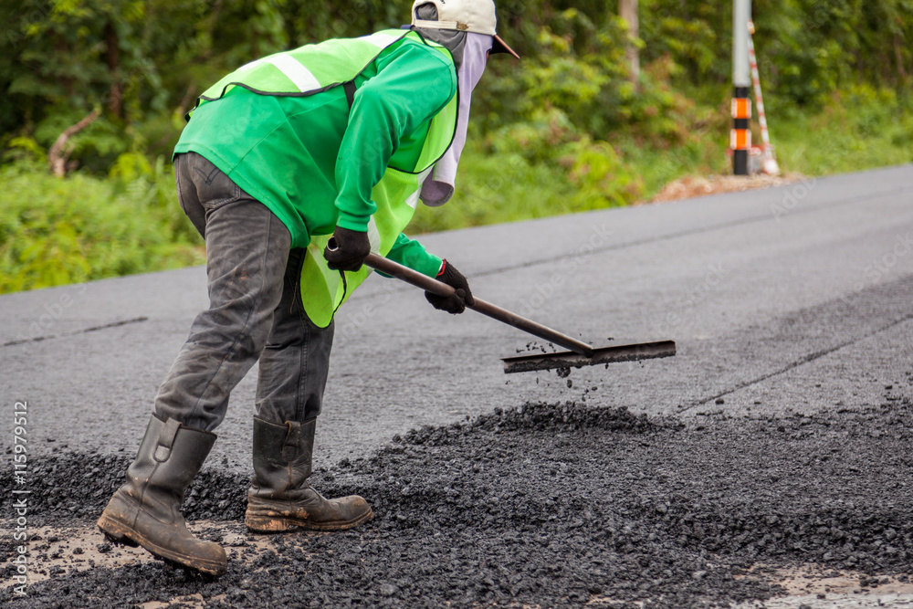 Road construction works with roller compactor machine and asphalt finisher