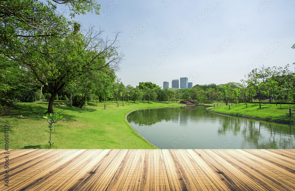 Wood table top on garden in city background