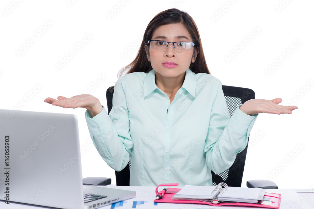 Confused asian young businesswoman at her desk