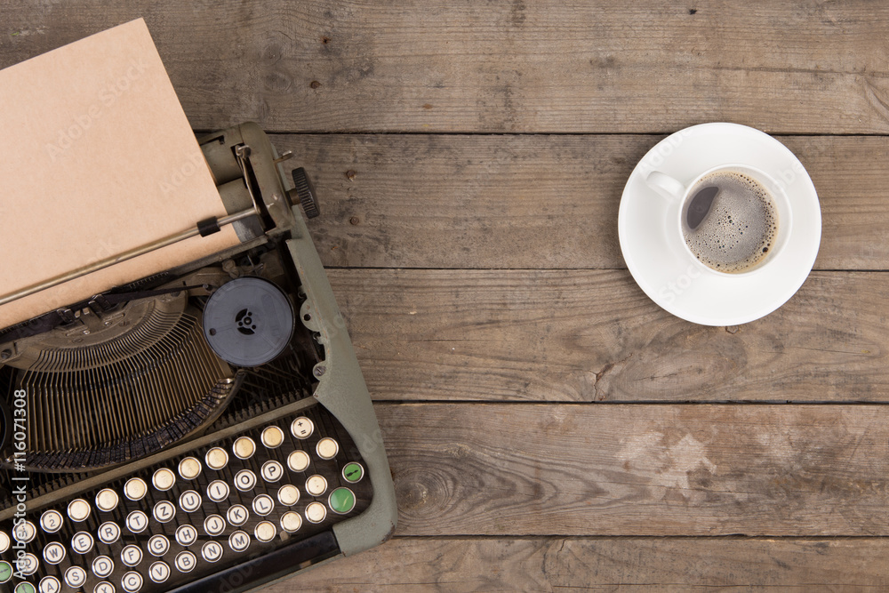 Vintage typewriter on the old wooden desk