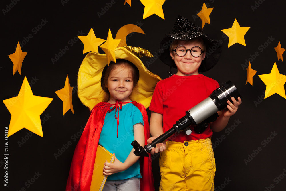 Cute kids playing sky watchers with a telescope