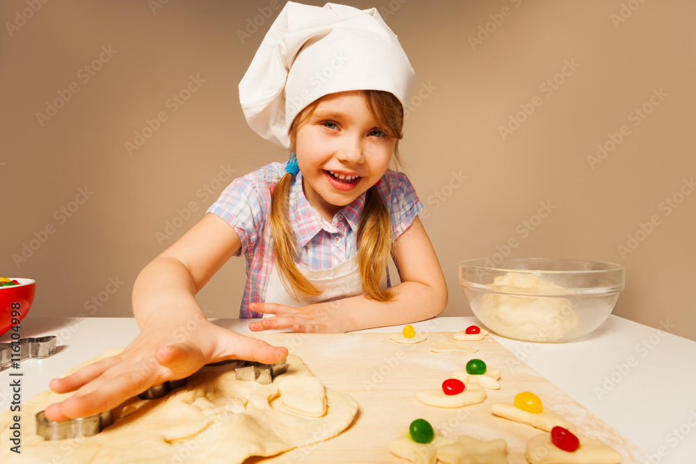 Cute girl playing baker making handmade cookies