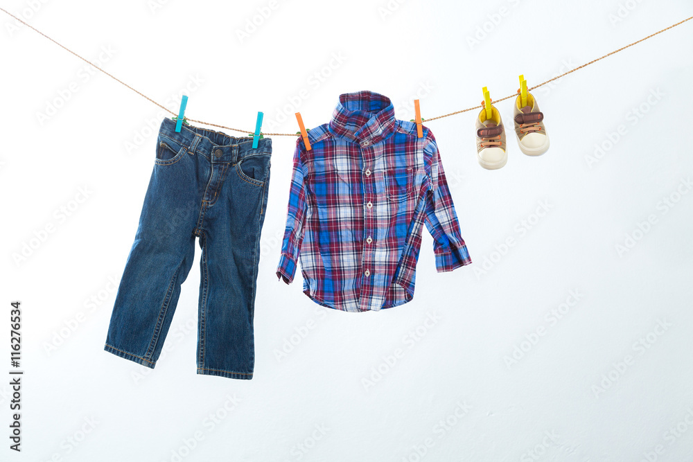 Baby clothes hanging on the rack isolated on white background.