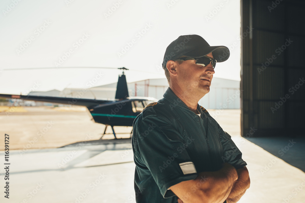 Helicopter pilot in airplane hangar