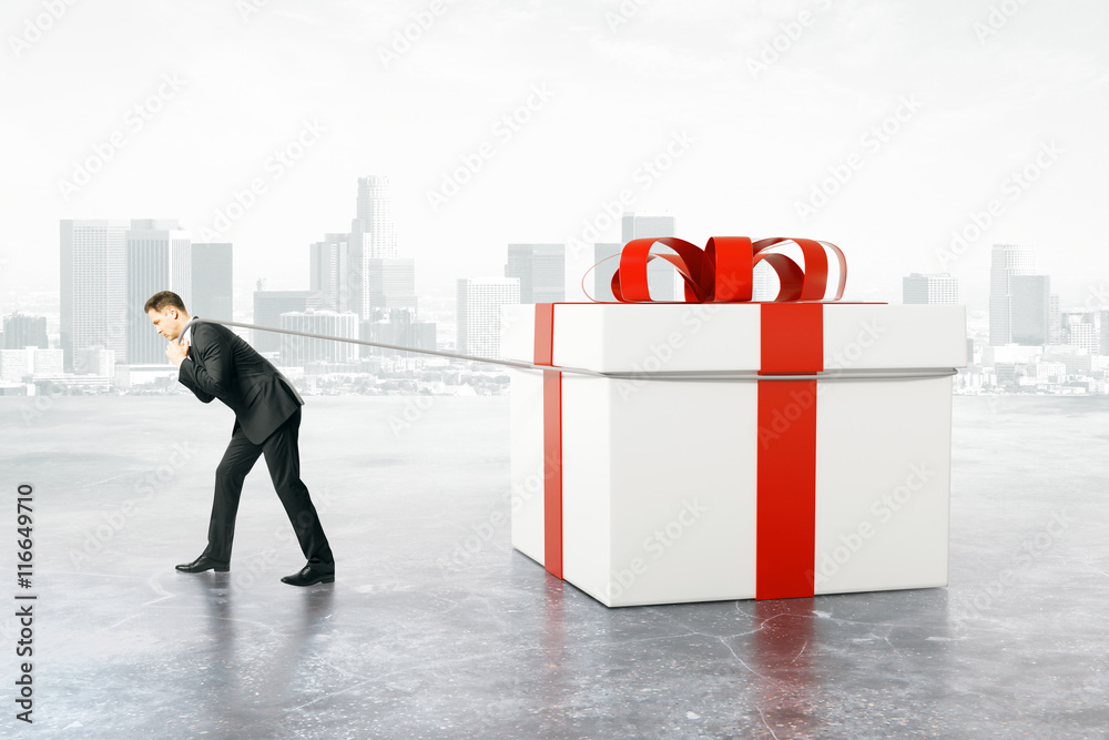 Man dragging present box