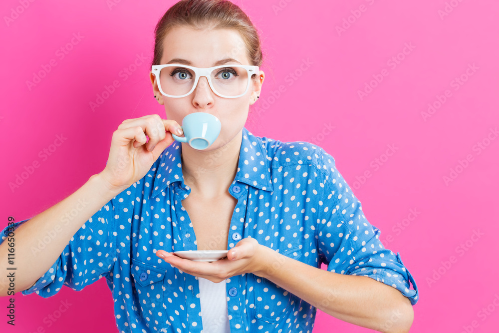 Happy young woman drinking coffee