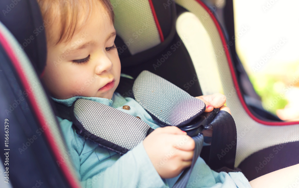 Toddler girl in her car seat