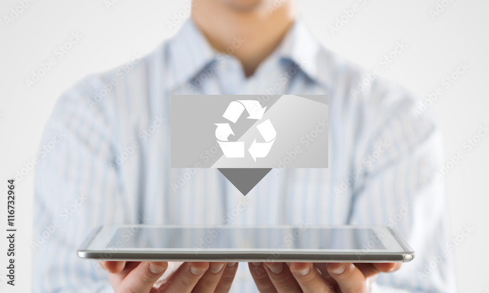 Businessman hand touch screen recycle sign icons on a tablet.