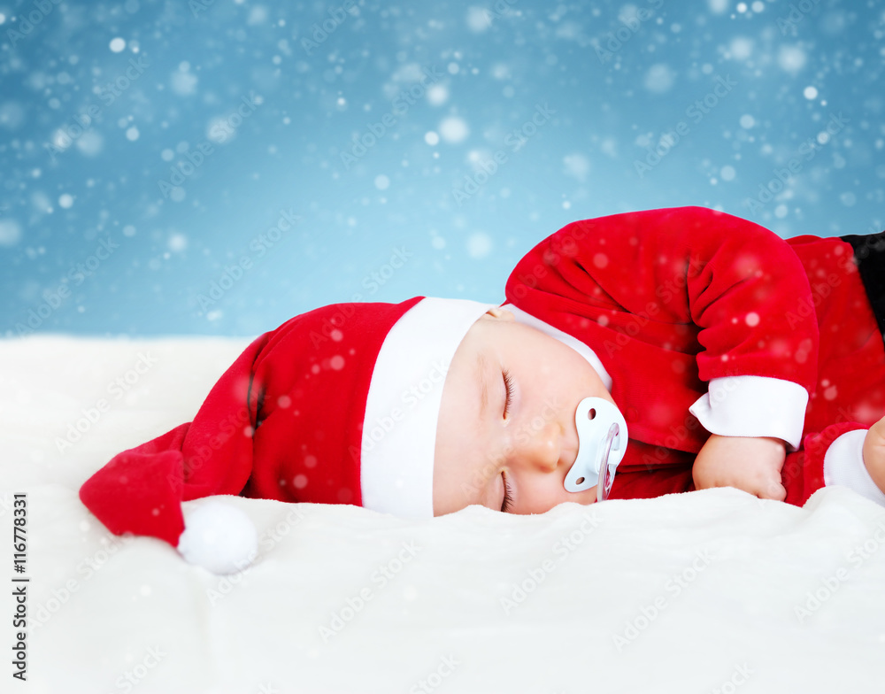 Baby sleeping in santa costume