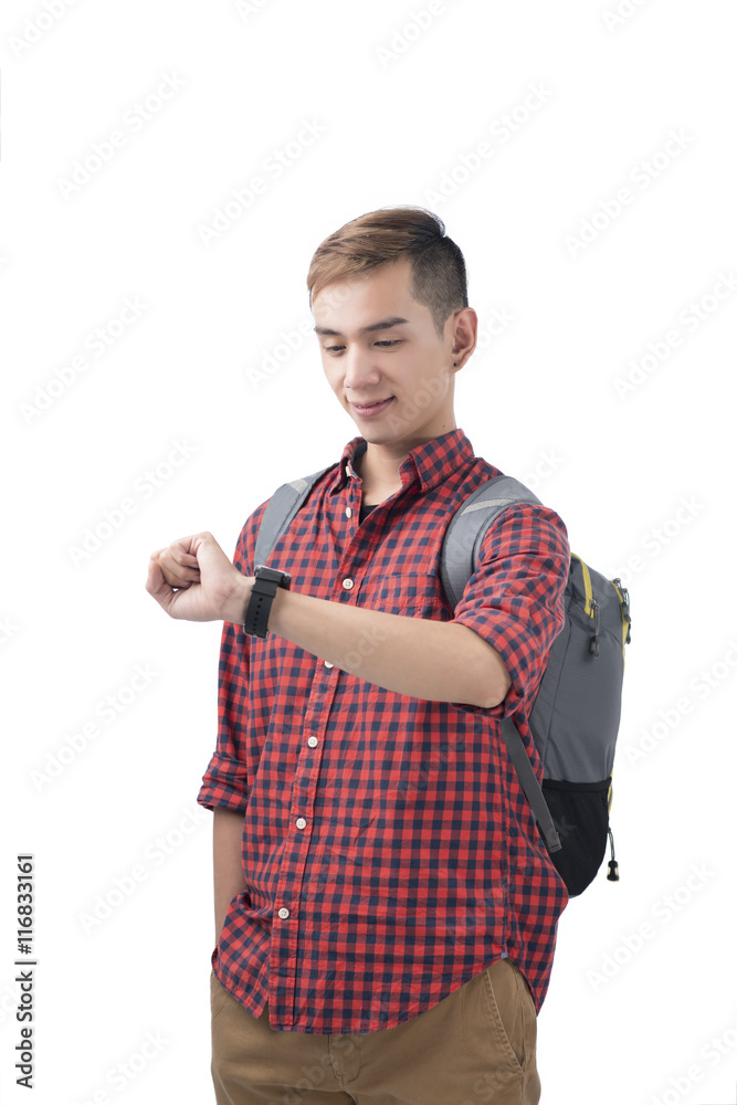 Portrait of a smiling student looking on wrist watch over white