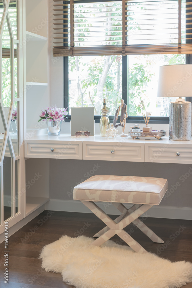 white dressing table and chair with womens accesories