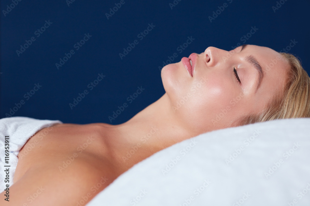 Attractive young woman relaxing on massage table