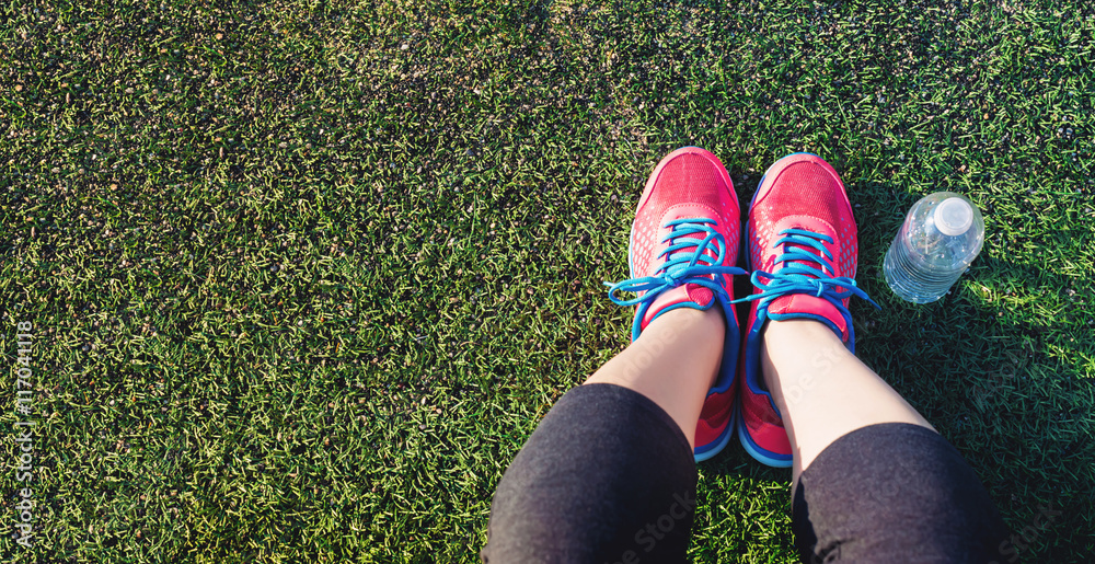 Female jogger looking down at her feet