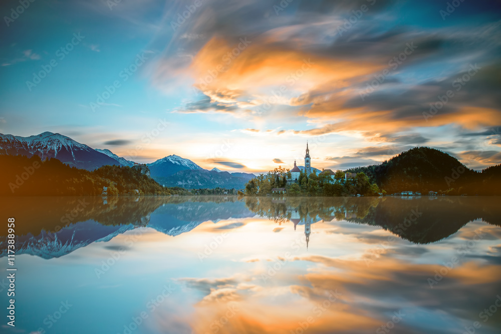 Beautiful morning landscape with snowed up Alpes on the Bled lake in Slovenia. Long exposure image t