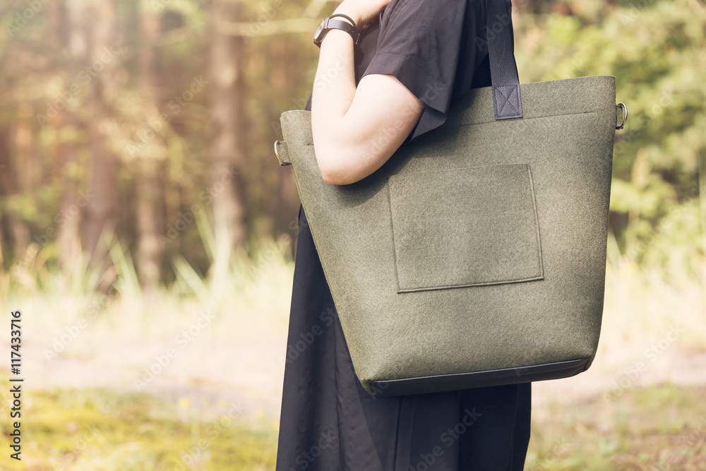 khaki color felt bag on womans shoulder