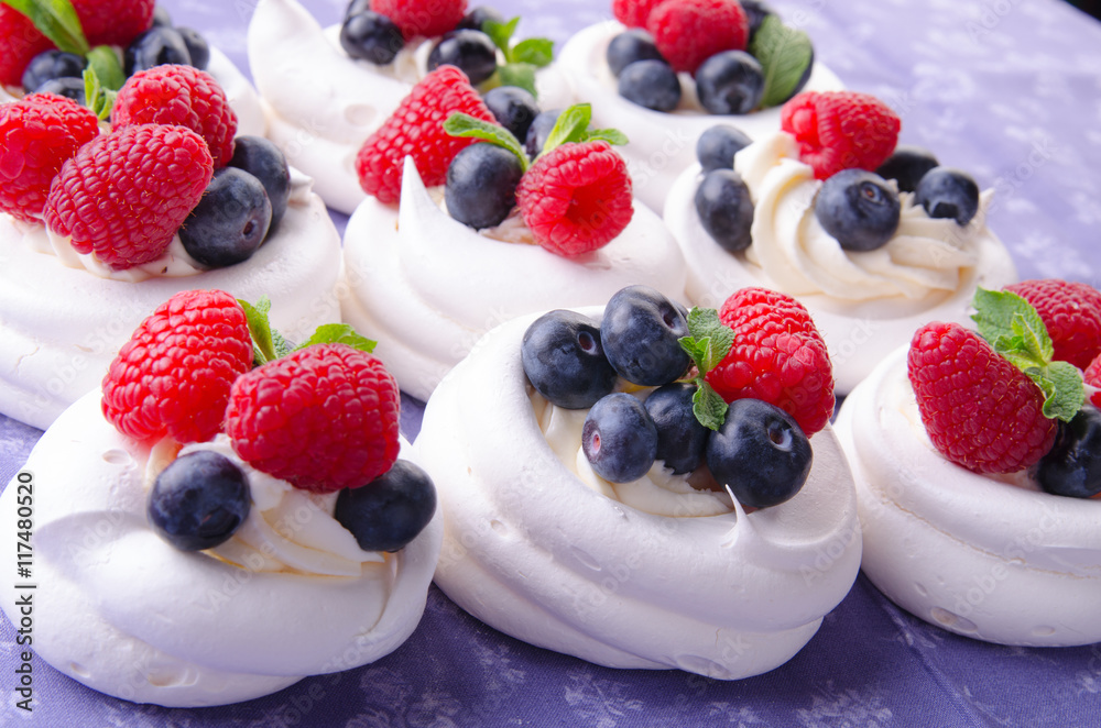 Homemade pavlova meringue cake with fresh berries and whipped cream. Morning. Dessert.