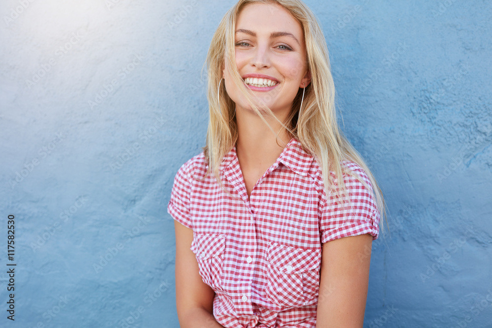 Cheerful young woman looking at camera and smiling