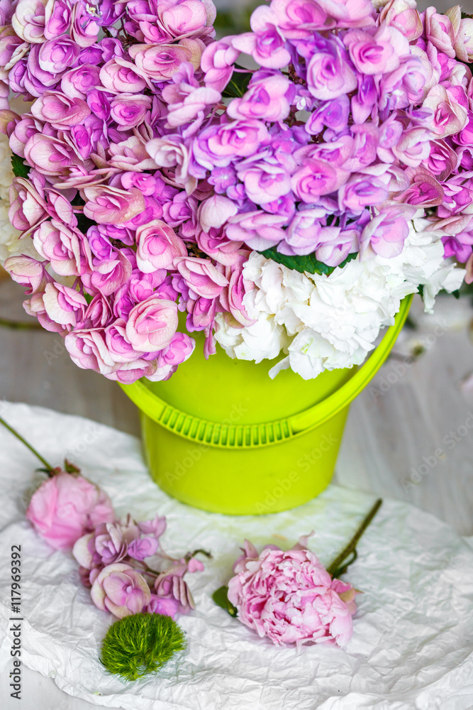 flowers in green bucket at workshop