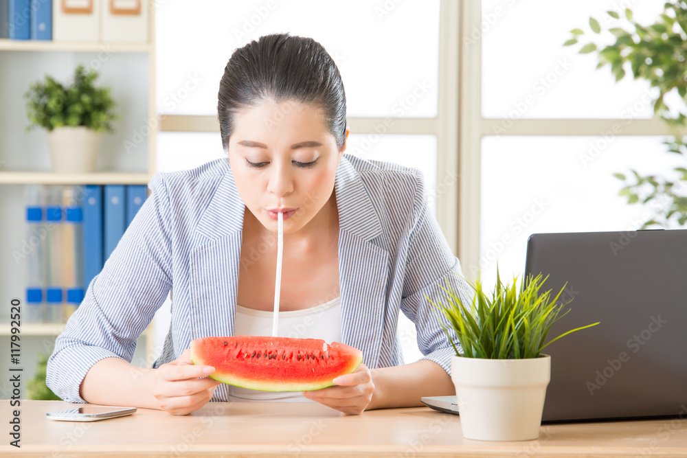 自信的商务女性享受真正的油炸西瓜汁