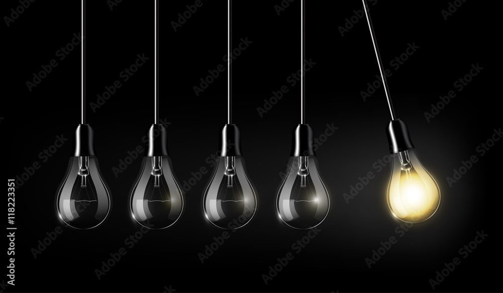 Glowing light bulb is among a lot of turned off light bulbs on dark blue background , concept idea, 