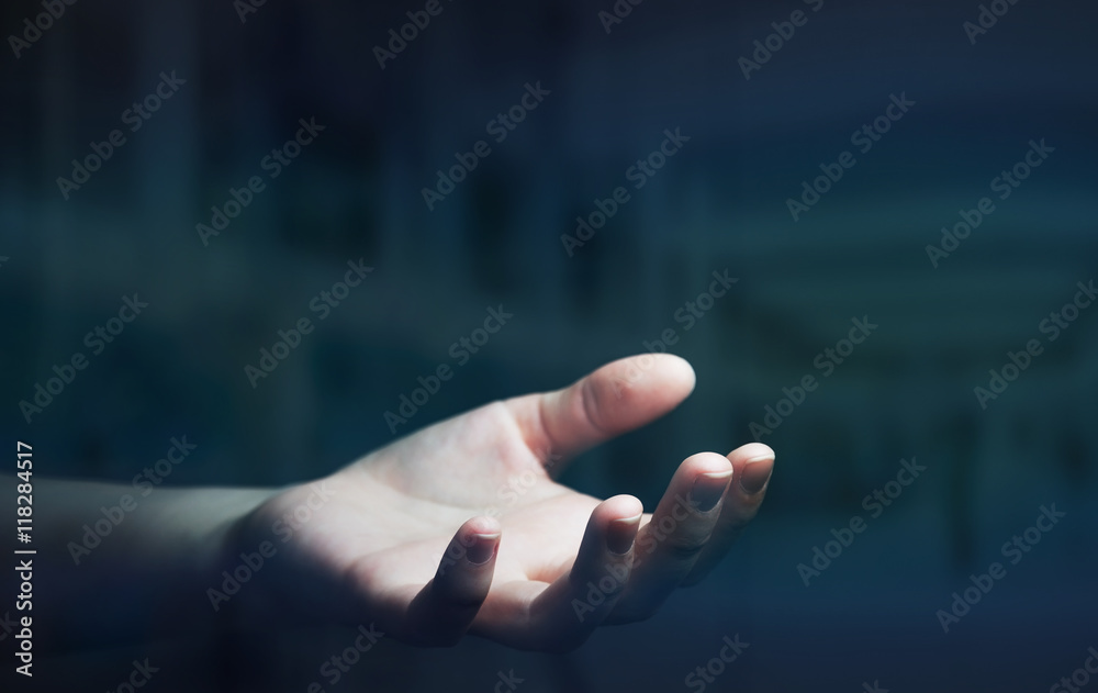 Businesswoman hand on black dark background