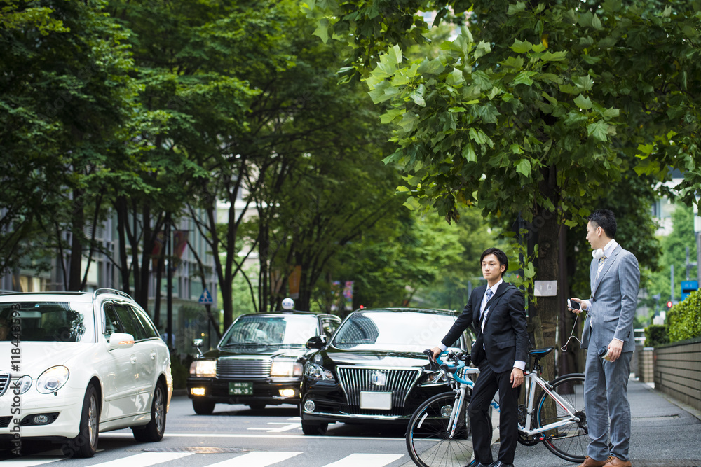 Businessmen have a signal waiting down from the bike