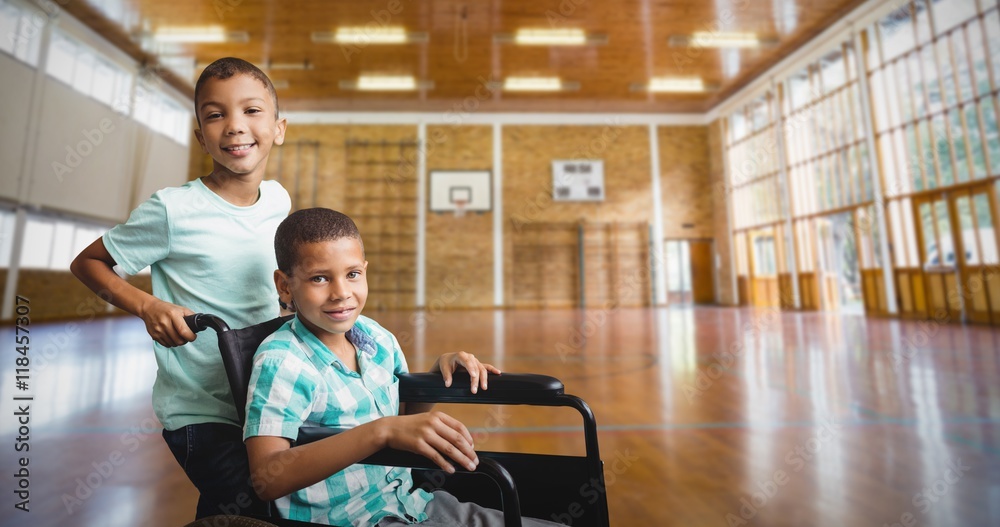 Composite image of boy pushing friend wheelchair