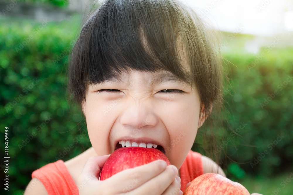 Funny food little girl with red Apple smiling happy. Healthy eating and vegetables concept photo
