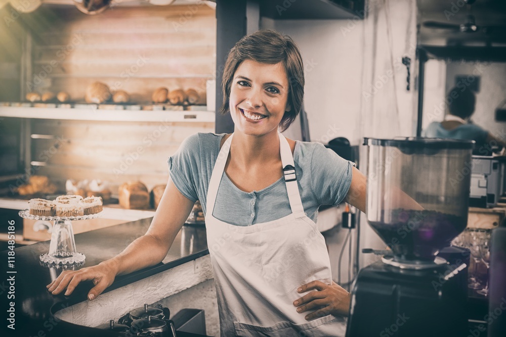 Pretty barista smiling at camera