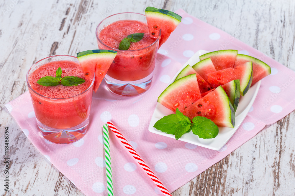 Glasses of watermelon smoothie on a wooden table