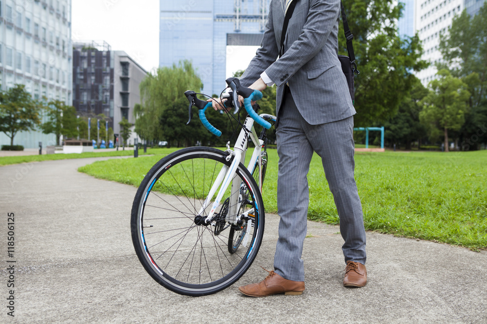 Businessman walking down from the bike