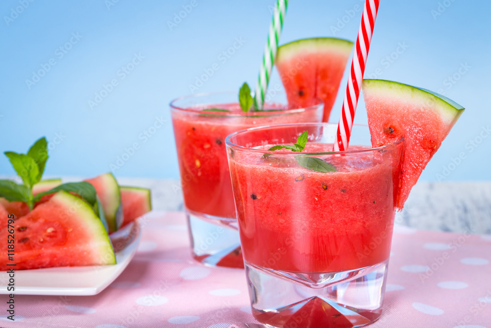 Glasses of watermelon smoothie on a wooden table