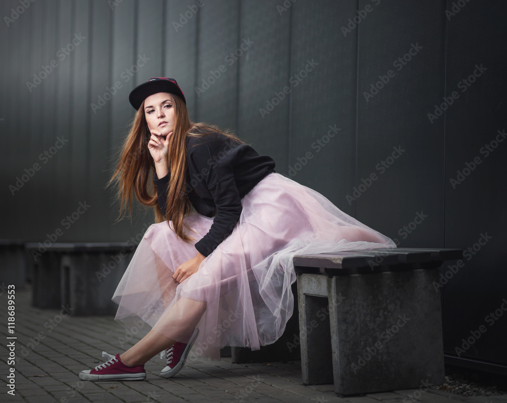 Trendy beautiful long haired girl posing, hip hop fashion