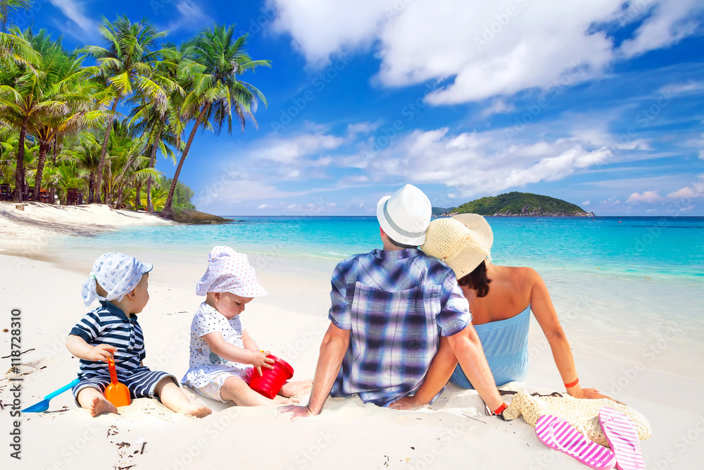 Family with twins on sun holidays at the tropical beach