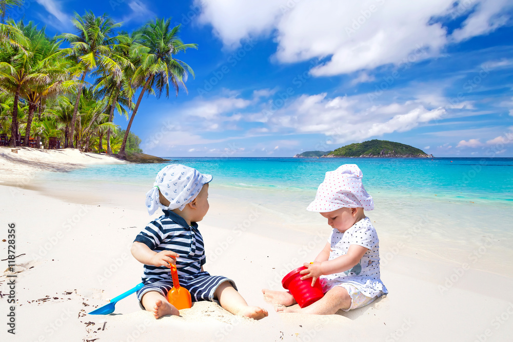 Family with twins on sun holidays at the tropical beach