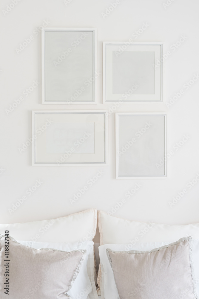 white blank picture frames hanging on white