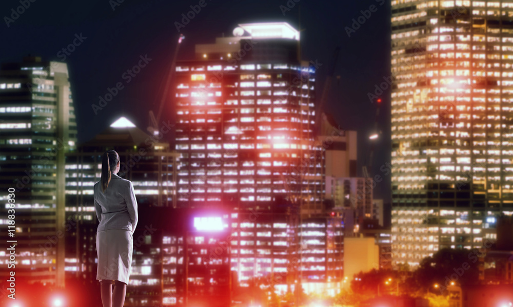 Woman looking at night city