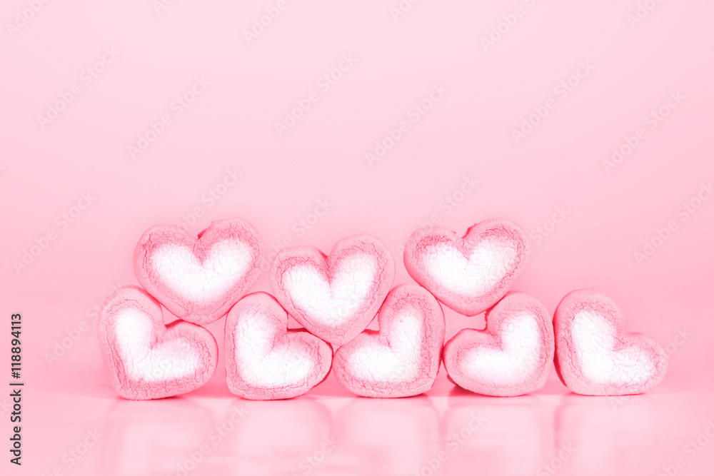 the marshmallow heart shape on pink background with love concept