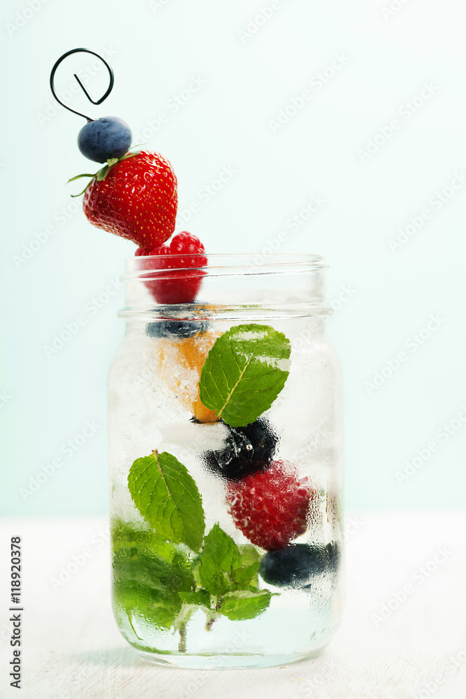 Detox fruit infused flavored water Fresh summer fruits on metal