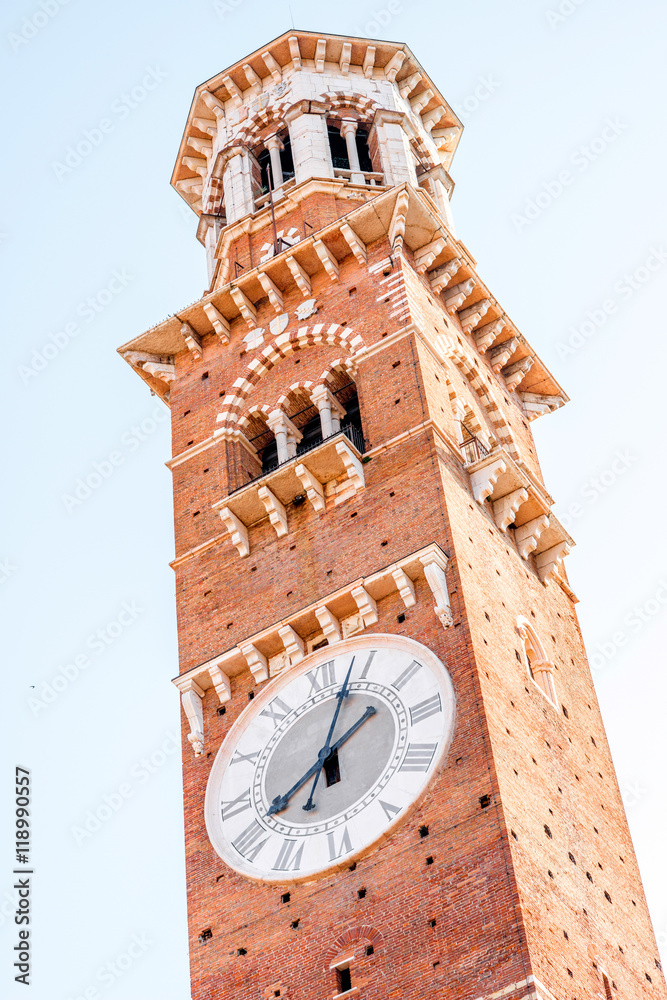 Close-up view on Lamberti tower with clock in Verona city in Italy