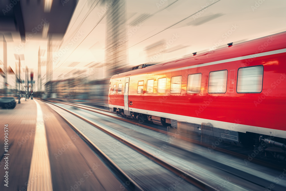 Modern high speed red passenger commuter train. Railway station