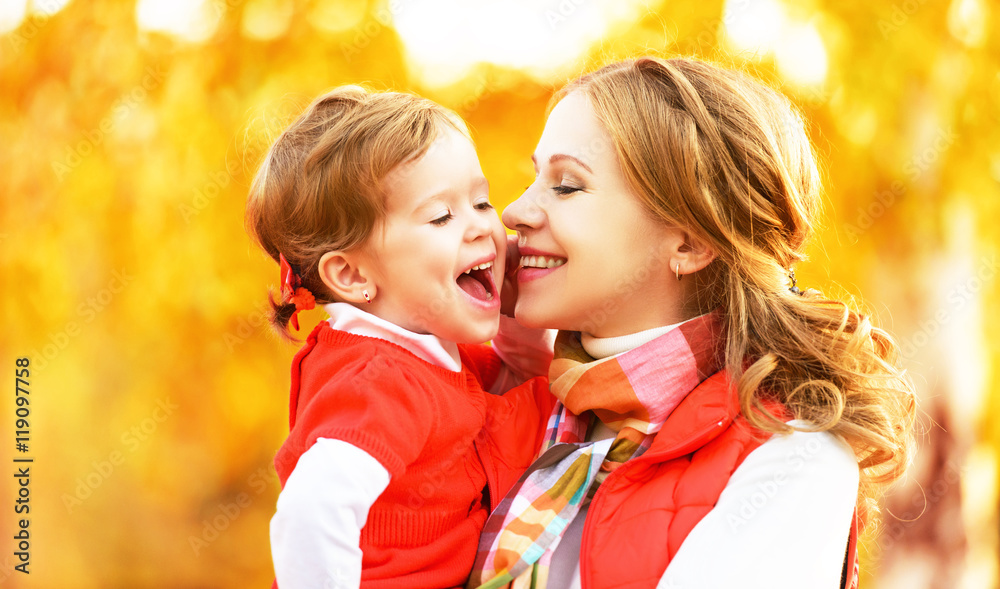 happy family. mother and child little daughter play kissing on a