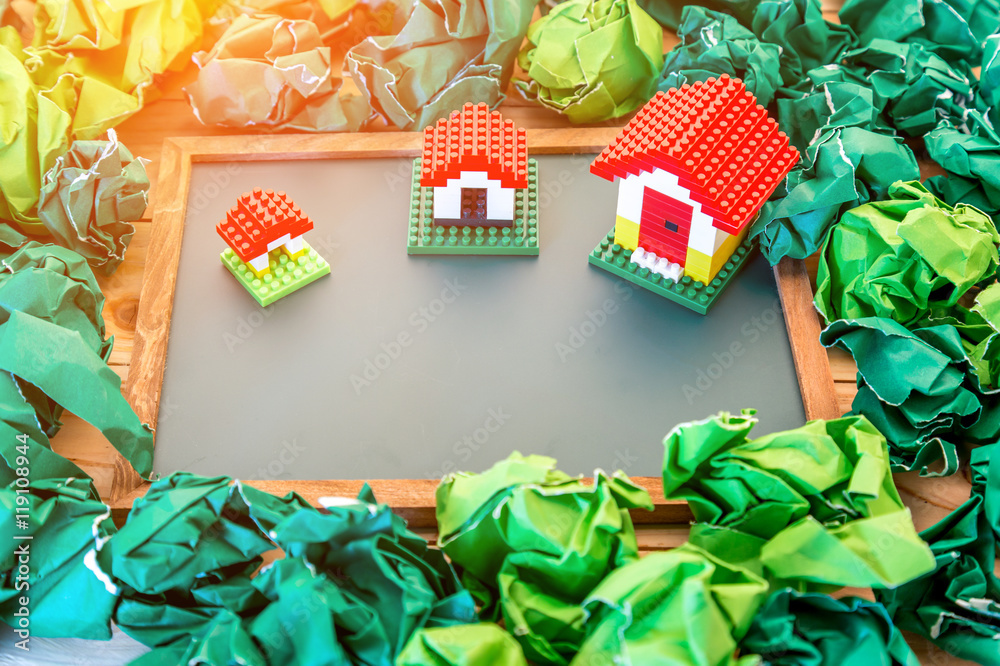 model of plastic house building with trash paper