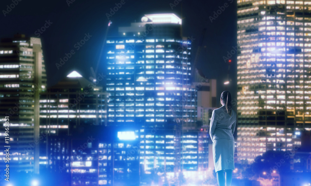 Woman looking at night city