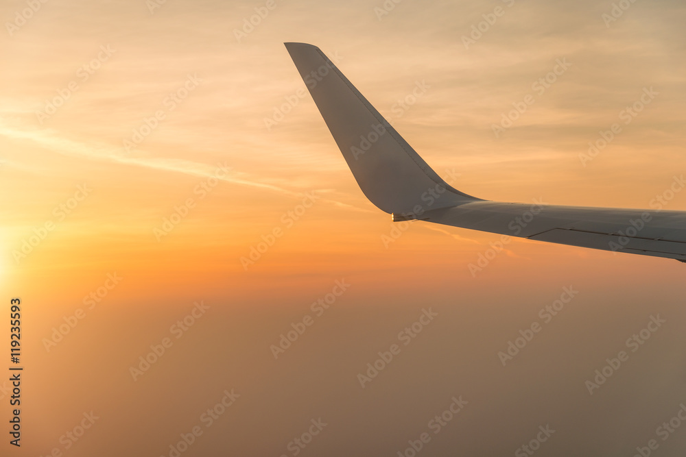 Wing of airplane in the sunset