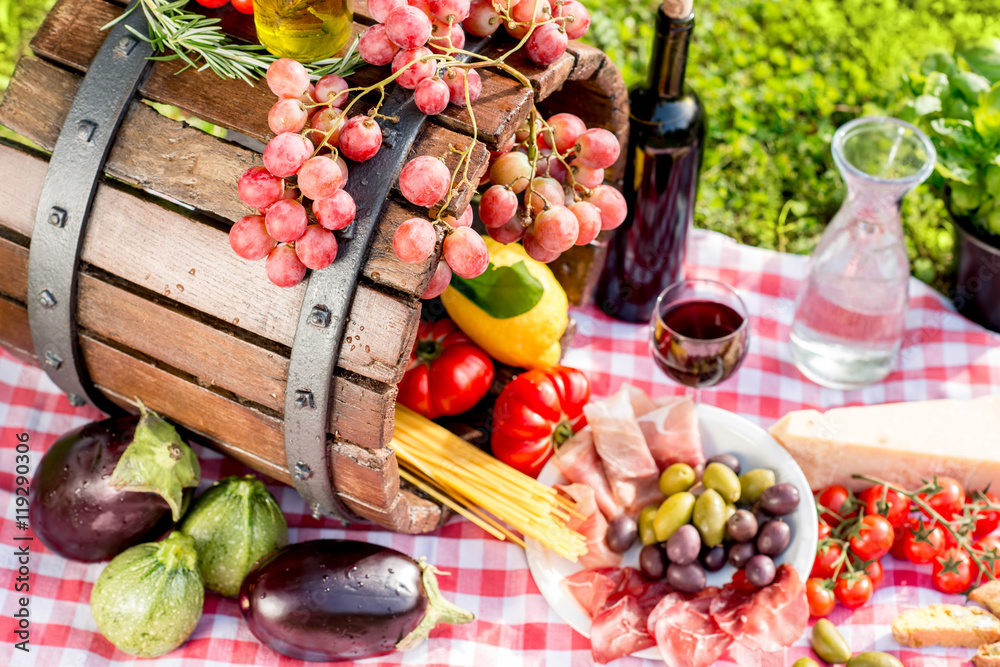 Lots of tasty italian food on the napkin and wooden barrel outdoors