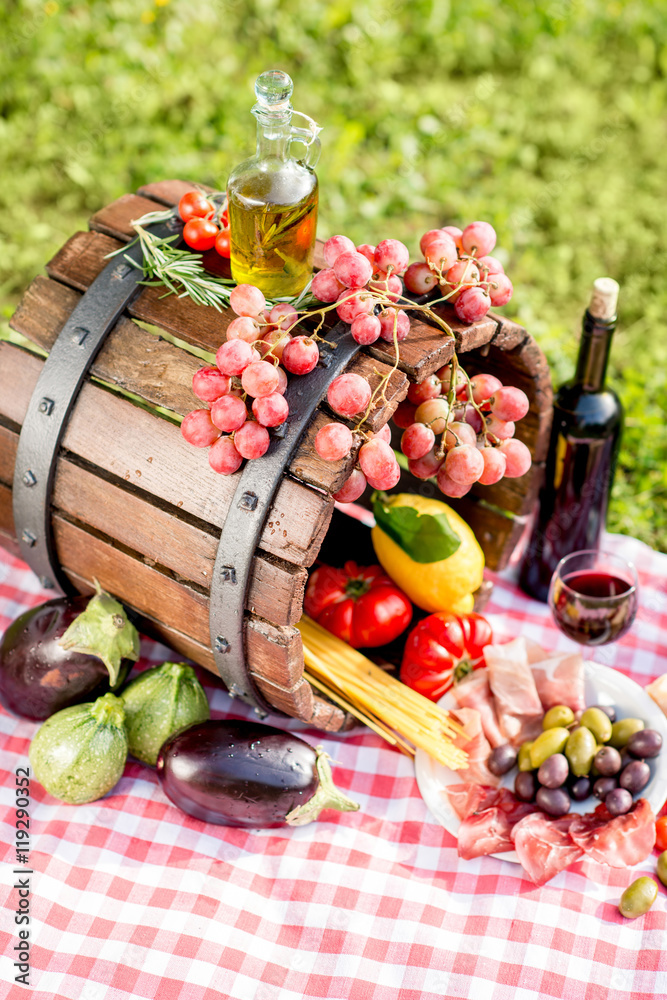 Lots of tasty italian food on the napkin and wooden barrel outdoors